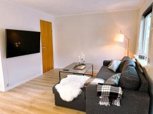 a living room with a couch and a table at Cozy apartment in Klaksvík in Klaksvík