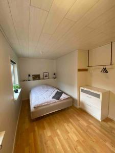 a bedroom with a bed and a wooden floor at Cozy apartment in Klaksvík in Klaksvík