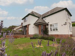 a house with a yard with purple flowers at Bryn Gwynedd in Conwy