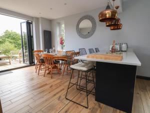 a kitchen and dining room with a table and chairs at Bryn Gwynedd in Conwy