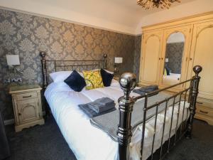 a bedroom with a bed with a black frame at Bryn Gwynedd in Conwy