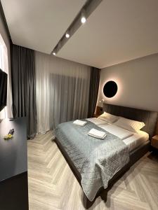 a bedroom with a bed with two towels on it at Luxury by The Lake Ap 28 in Sibiu
