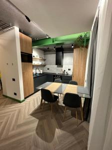 a kitchen and dining room with a table and chairs at Luxury by The Lake Ap 28 in Sibiu +50 photos