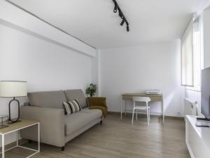 a living room with a couch and a table at Munoa By Kabia Gestion in Barakaldo