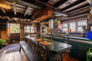 a large kitchen with a large island with a bench at La Casa Rectoral de El Tozu in Caso