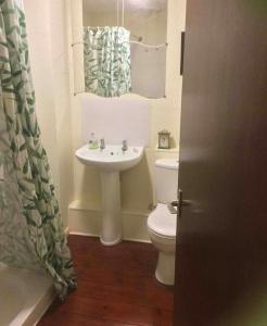 a white bathroom with a sink and a toilet at Hillside View in Redditch