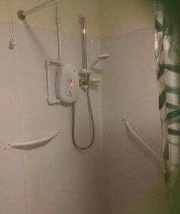 a shower in a bathroom with a shower head at Hillside View in Redditch