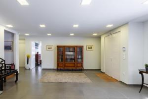 an empty hallway with a wooden door and a room at Astonished Central and Luxury Town House in Glyfada in Athens