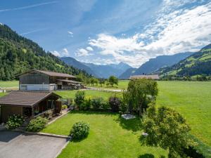 an aerial view of a house in a field with mountains at Ferienwohnung Wallner in Zell am Ziller