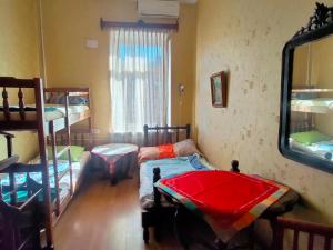 a room with two bunk beds and a mirror at Guest House Irina Tbilisi in Tbilisi City