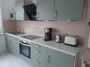 a kitchen with a counter top with a toaster and a appliance at barrierefreie Apartments in Kerken