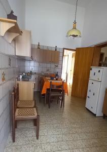 a kitchen with a table and chairs in a room at La Casina Di Nonna Ida in Ruffano