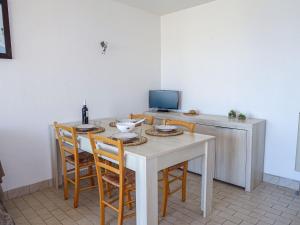a dining room with a table and chairs at Apartment Les Balcons de la Méditerranée-14 by Interhome in Narbonne-Plage