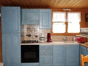 a kitchen with blue cabinets and a sink at Apartment Rubigny by Interhome in Saint-Gervais-les-Bains