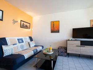 sala de estar con sofá y TV de pantalla plana en Apartment Le Florid-3 by Interhome, en Cap d'Agde