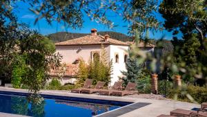 a house with a swimming pool in front of a house at Eco Hotel con encanto Masía la Mota B&B in Alcoy