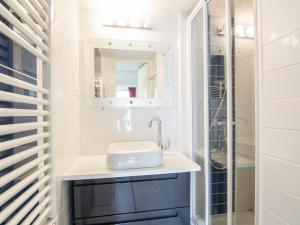 a bathroom with a sink and a shower at Holiday Home Les Cristallines-2 by Interhome in Cap d'Agde