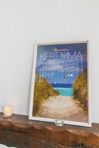 a picture of a beach in a picture frame on a table at Holiday Home Tal Ar Mor - PLC213 by Interhome in Plounévez-Lochrist