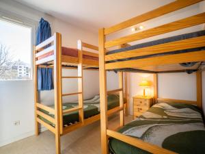 a bedroom with two bunk beds and a window at Holiday Home Les Lavandines 1-6 by Interhome in Cap d'Agde