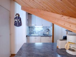a kitchen with a counter top and a kitchen with a counter top at Apartment Les Combettes D et E by Interhome in Les Contamines-Montjoie