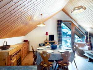 a kitchen with a table and chairs in a room at Apartment Les Combettes D et E by Interhome in Les Contamines-Montjoie