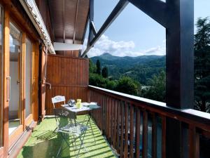 a balcony with a table and a view of the mountains at Apartment le Martagon-1 by Interhome in Saint-Gervais-les-Bains