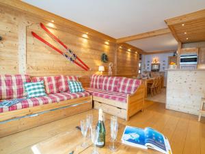 a living room with two couches and a table at Apartment Le Bec Rouge - Le Lac-2 by Interhome in Tignes