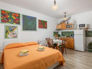 a bedroom with a bed and a kitchen with a table at Apartment Sandalj-2 by Interhome in Kraj