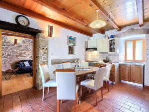 a kitchen and dining room with a table and chairs at Holiday Home Donada - LBN347 in Nedeščina