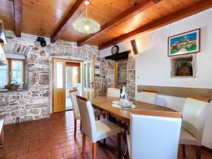 a dining room with a wooden table and chairs at Holiday Home Donada - LBN347 in Nedeščina