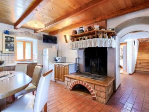 a living room with a fireplace in a kitchen at Holiday Home Donada - LBN347 in Nedeščina
