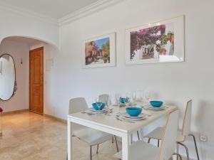 a white dining room with a white table and chairs at Apartment Marina Bay-1 by Interhome in Estepona