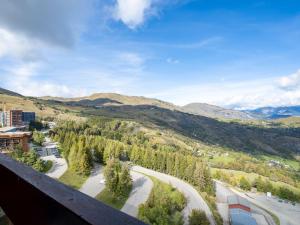 a view from the balcony of a mountain at Apartment Soyouz Vanguard-65 by Interhome in Le Corbier