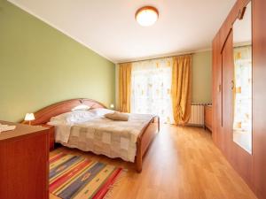a bedroom with a bed and a large window at Apartment Markulin by Interhome in Rubeši