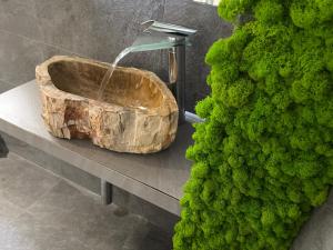 a bathroom with a stone sink with a water fountain at Cinecittà Luxury GUEST HOUSE in Rome