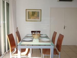 a dining room with a table and chairs at Apartment Les Jardins de Neptune by Interhome in Virebelle