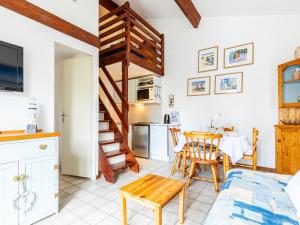 a kitchen and living room with a table and a dining room at Holiday Home Hameau de Talaris-3 by Interhome in La Palmyre