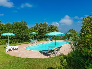 a swimming pool with chairs and umbrellas at Holiday Home Poggio al Colle by Interhome in San Vivaldo