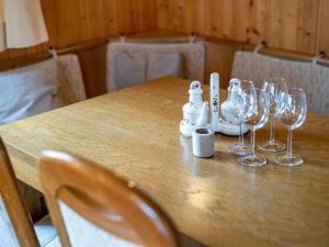 a wooden table with wine glasses on it at Holiday Home Romeo by Interhome in Dittishausen