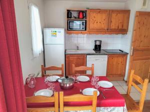 a kitchen with a table with a red table cloth at Apartment Le Grand Panorama-2 by Interhome in Saint-Gervais-les-Bains