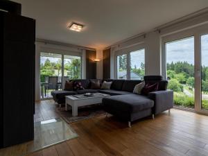 a living room with a couch and a table at Holiday Home Ambiente by Interhome in Dittishausen