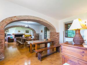 a living room with an archway and a dining room at Holiday Home Poggio al Colle by Interhome in San Vivaldo