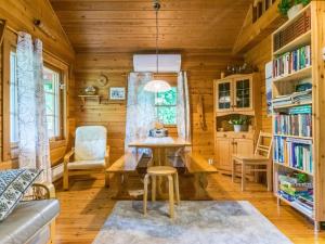 a dining room with a table and chairs in a cabin at Holiday Home Tuomola by Interhome in Lappajärvi