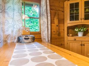 a kitchen with a toaster on the floor next to a window at Holiday Home Tuomola by Interhome in Lappajärvi