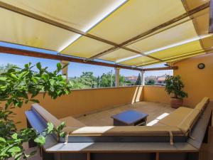 a patio with awning and a table on a balcony at Holiday Home Licardo by Interhome in Štinjan