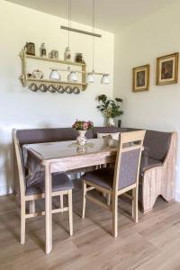 a dining room table with two chairs and a table and a dining room at Apartment Schwarzwaldblick-14 by Interhome in Schonach