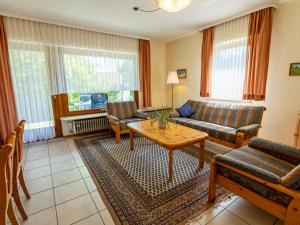 a living room with a couch and a table at Holiday Home Vergissmeinnicht by Interhome in Dittishausen