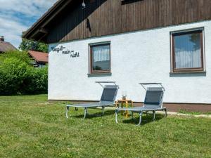 two chairs and a table in front of a building at Holiday Home Vergissmeinnicht by Interhome in Dittishausen