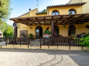 a house with a wooden fence in front of it at Holiday Home Decameron house by Interhome in Certaldo