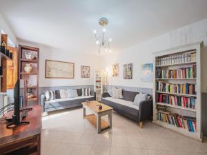 a living room with a couch and a tv at Holiday Home La Grande Aia by Interhome in Seravezza +39 photos